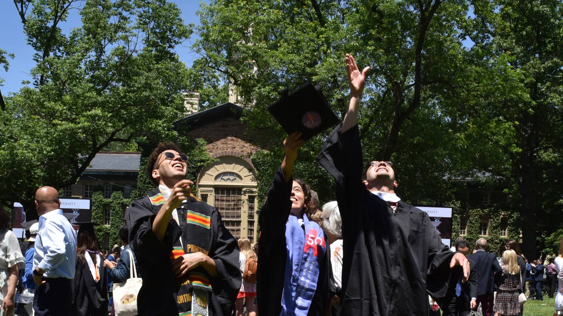 Graduates throw thier mortarboards into the air
