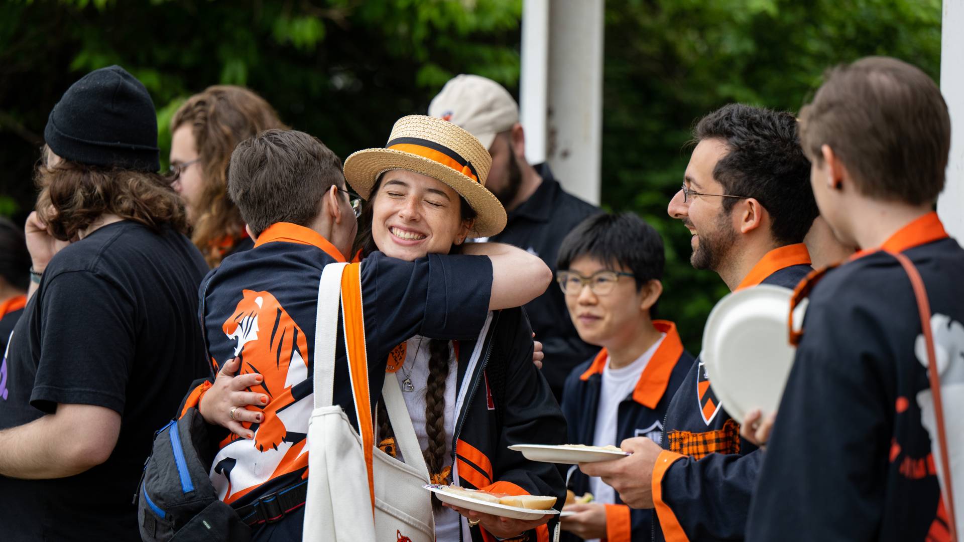 Alumni hugging one another