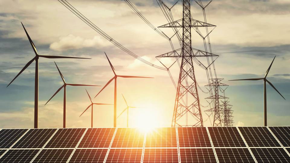 Wind turbines, power towers, solar panels and sunset