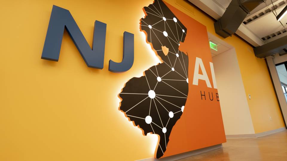 A wall display of the state of New Jersey flanked by "NJ" and "AI."