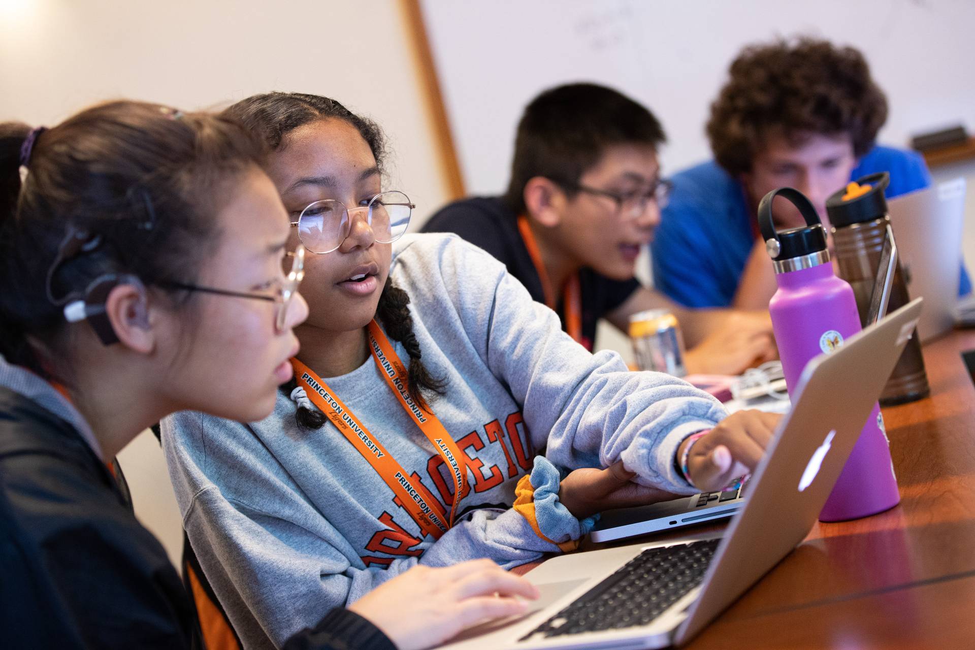 students leaning in to their computers