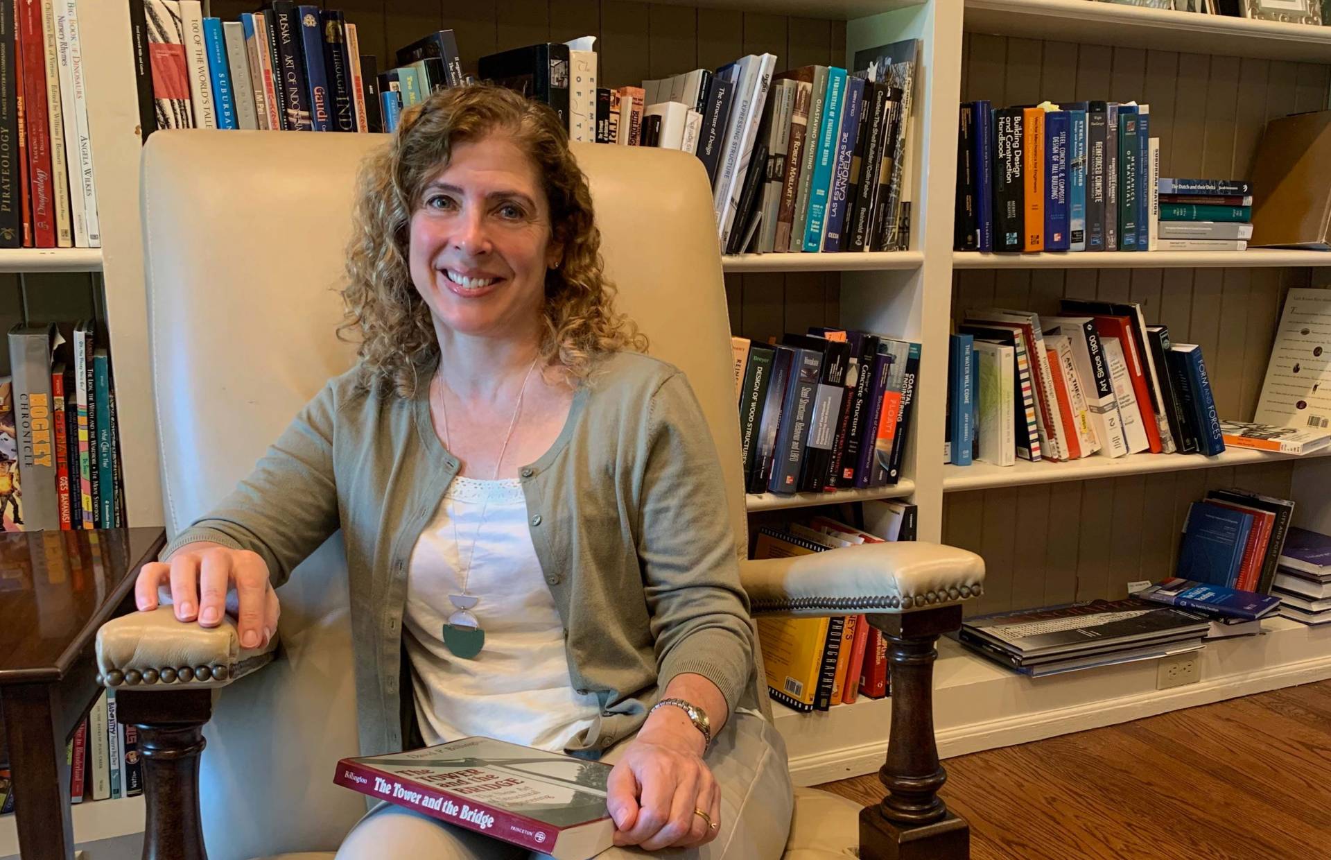 Maria Garlock in front of her bookshelves