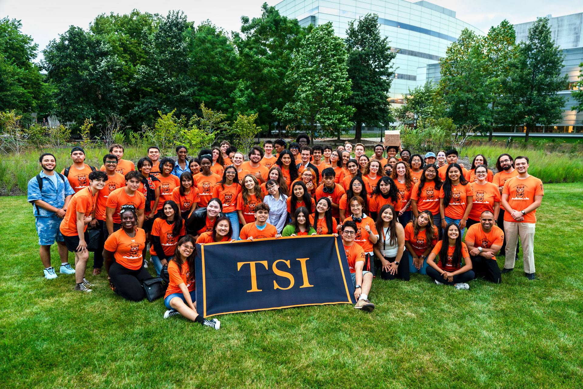 A large group of people holding a TSI banner