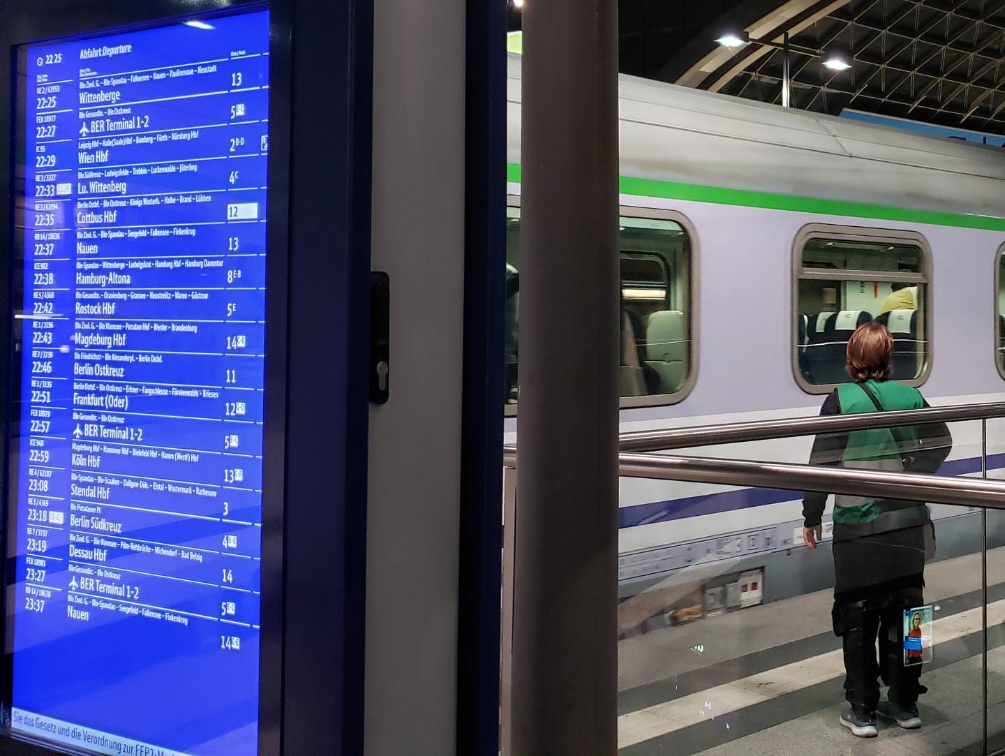 Berlin Train Station refugee-volunteer with a green vest